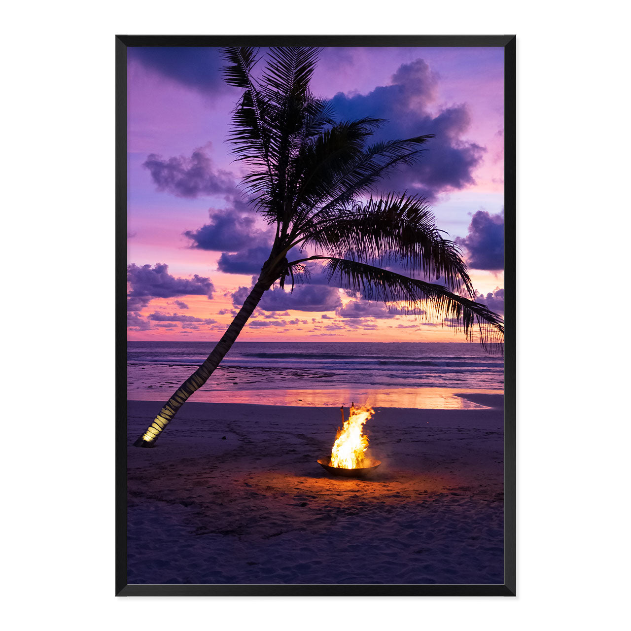 Framed photo of a fire pit by a palm tree on a beach with a sunset sky.