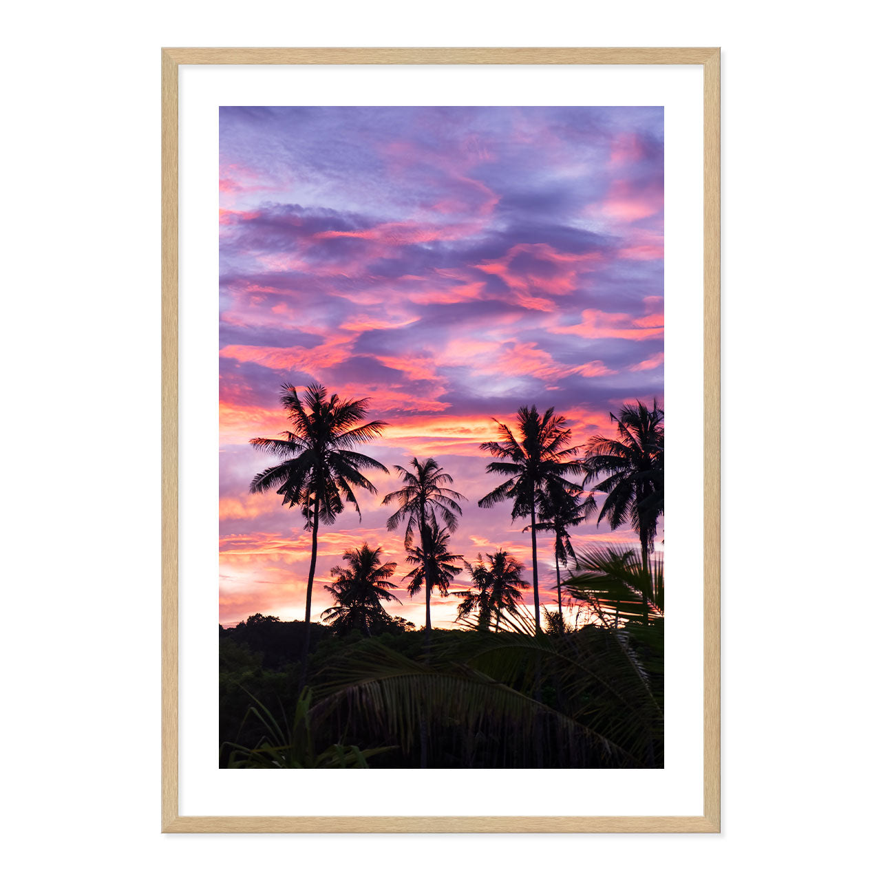 Framed artwork of palm trees against a vibrant purple and pink sunset sky.