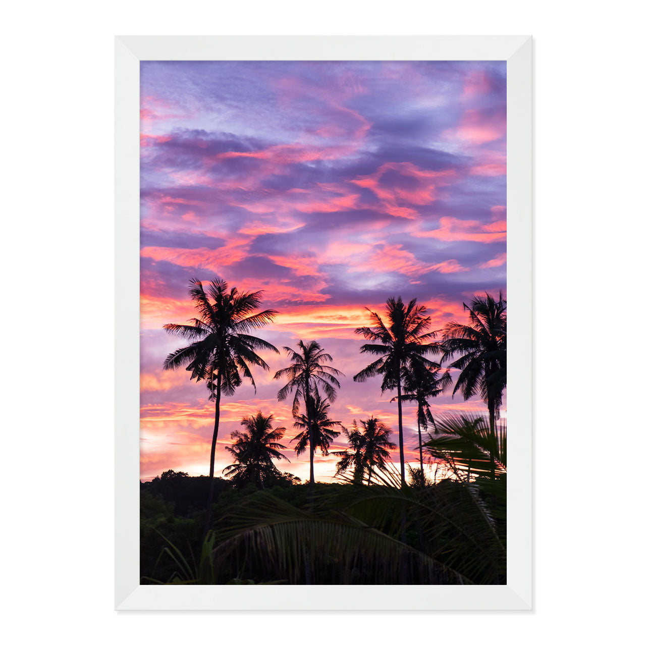 Framed artwork of palm trees against a vibrant purple and pink sunset sky.