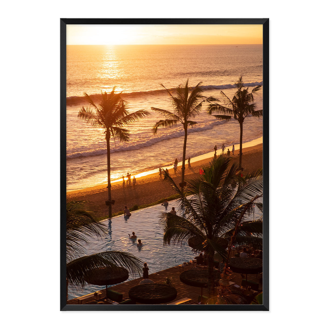 Framed artwork of a sunset over a beach with palm trees and people.