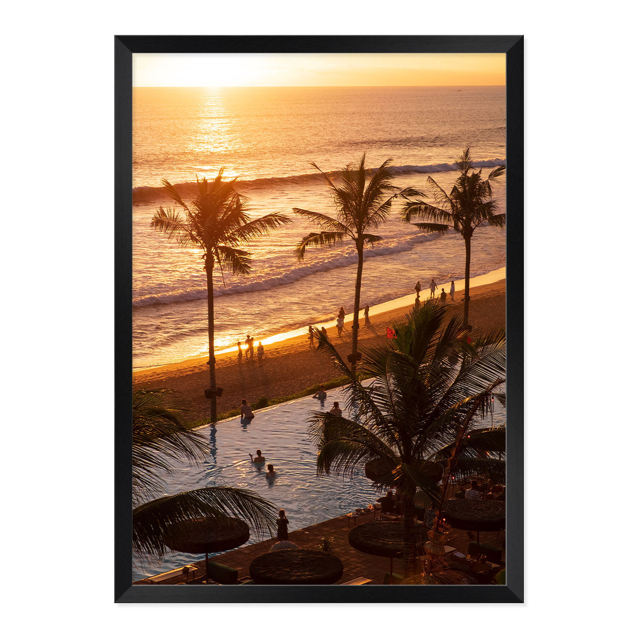 Framed artwork of a sunset over a beach with palm trees and people.