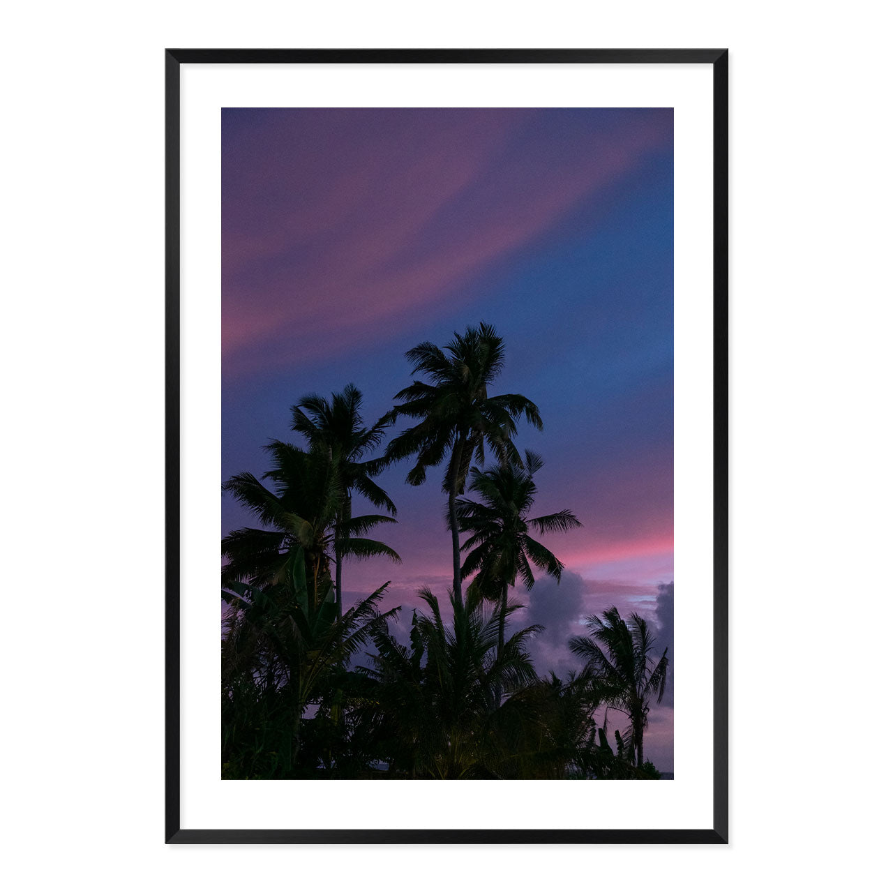 Framed artwork of palm trees against a purple sky