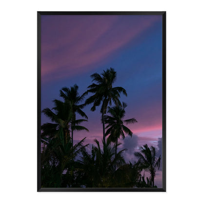 Framed artwork of palm trees against a purple sky