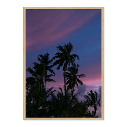 Framed artwork of palm trees against a purple sky