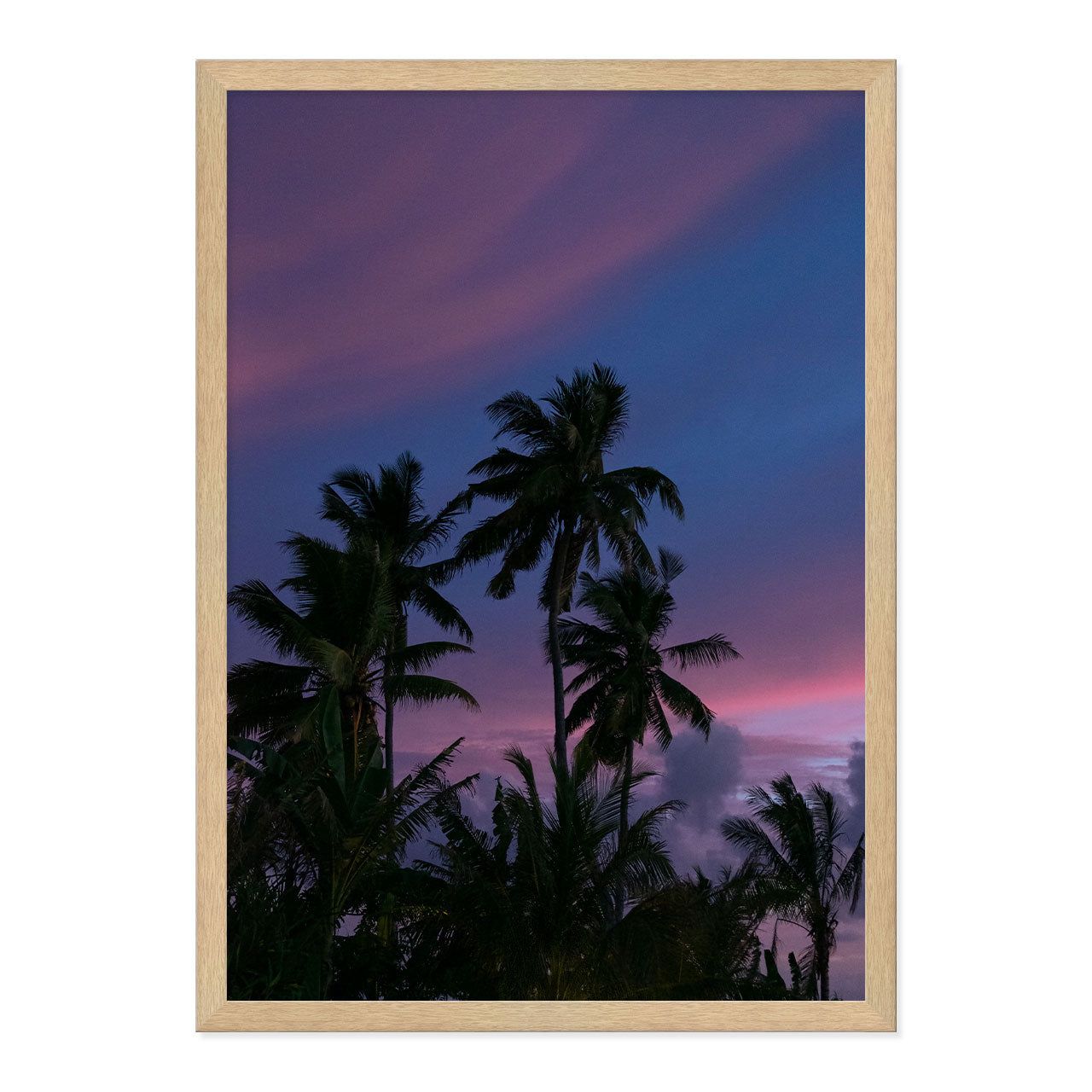 Framed artwork of palm trees against a purple sky