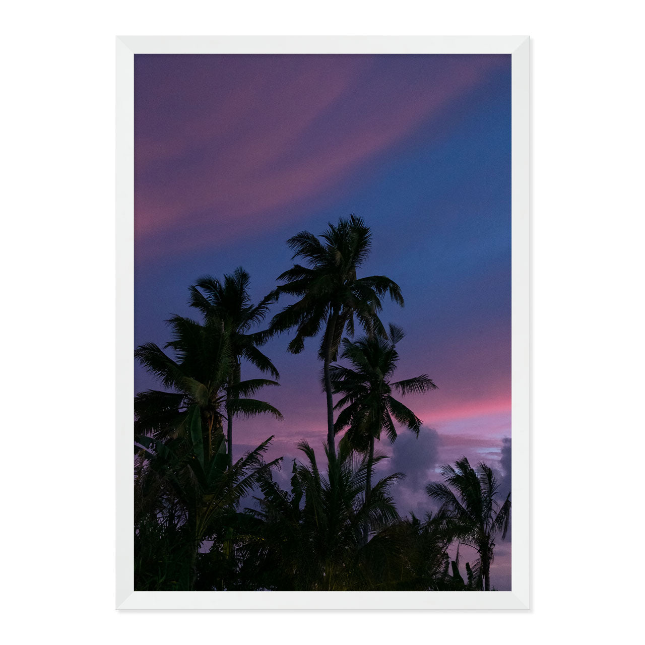 Framed artwork of palm trees against a purple sky
