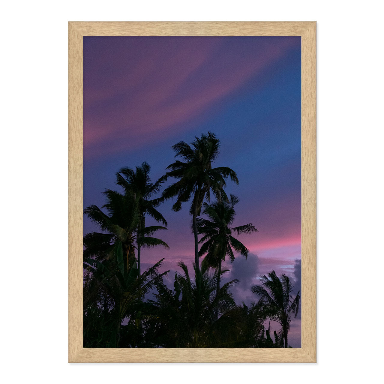 Framed artwork of palm trees against a purple sky
