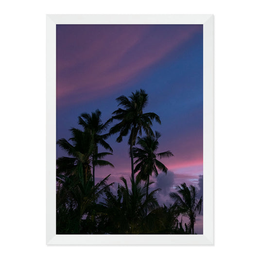 Framed artwork of palm trees against a purple sky