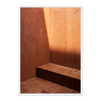 Ceramic tile with a wooden bench against a textured wall