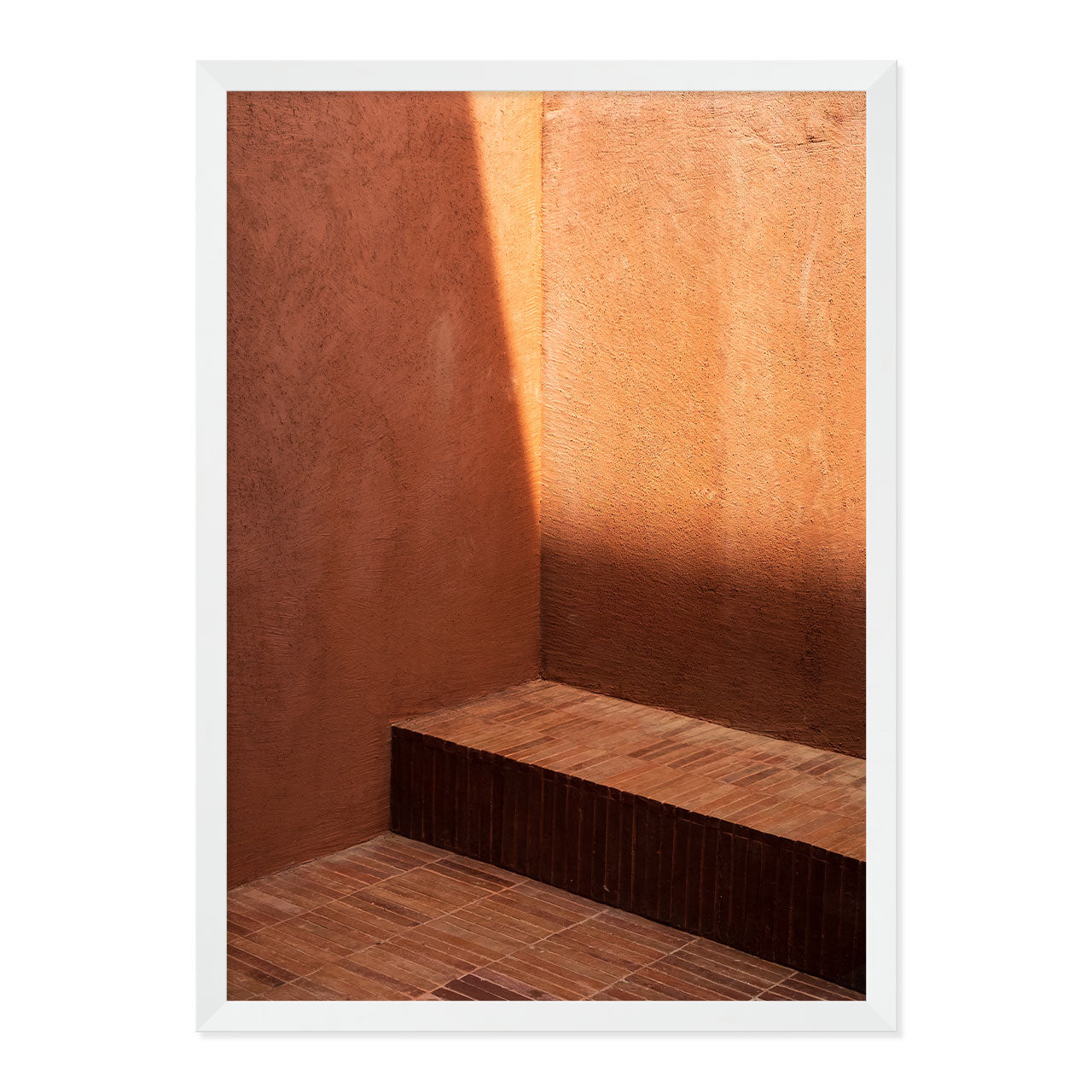Wooden bench against a textured brown wall with a white frame.