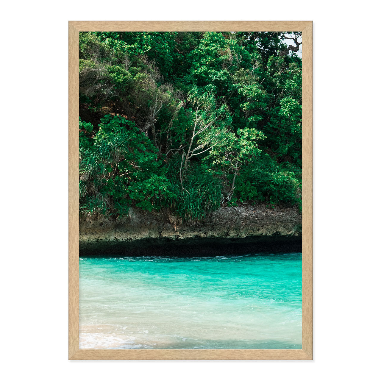 Framed artwork of a tropical landscape with greenery and turquoise water.