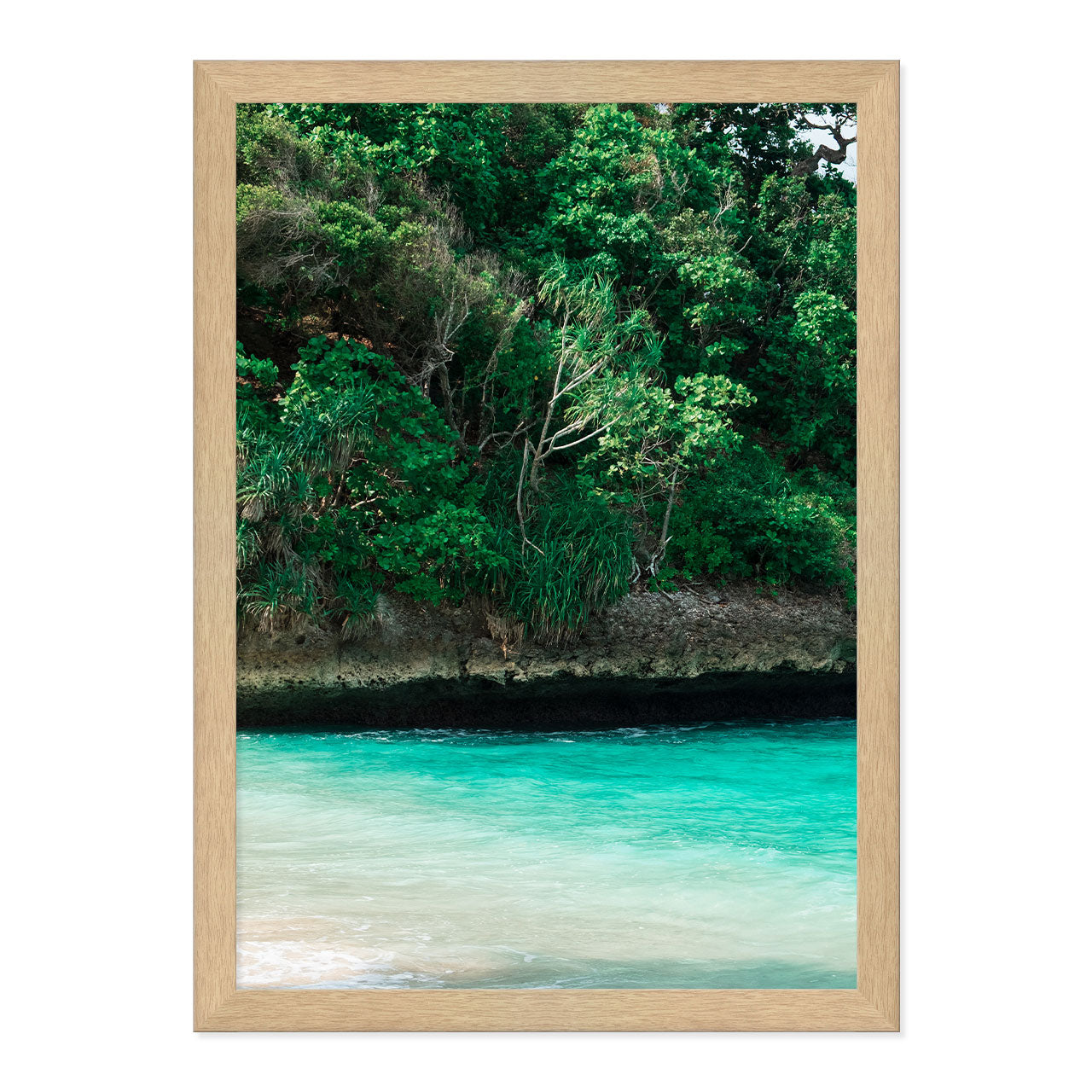 Framed artwork of a tropical landscape with greenery and turquoise water.