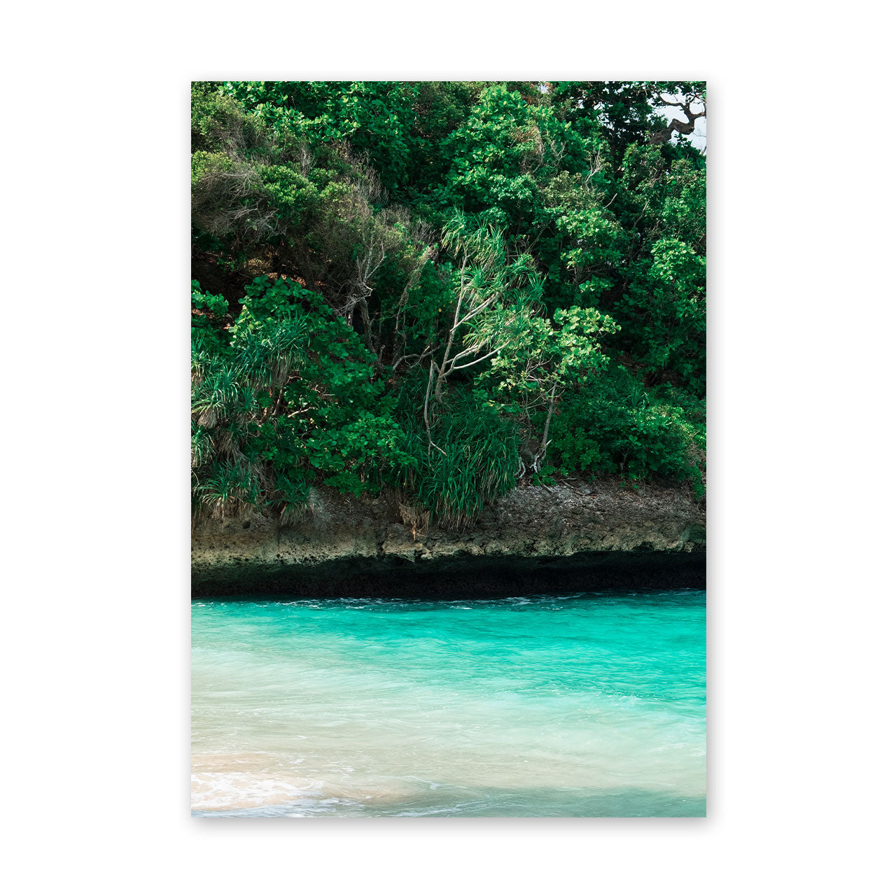 Framed artwork of a tropical landscape with greenery and turquoise water.